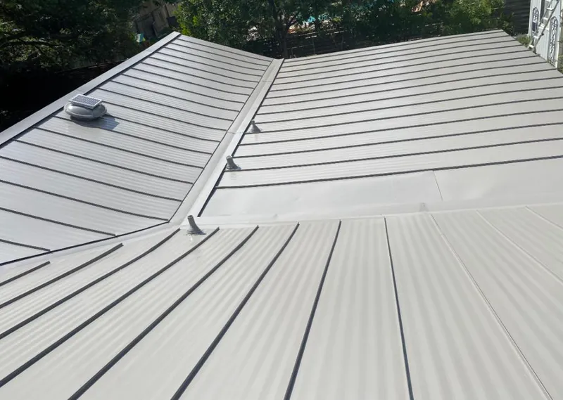 Solar attic fan installed on a metal roof for Roof Ventilation in Palm Bay